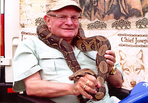 Don with pet snake around neck